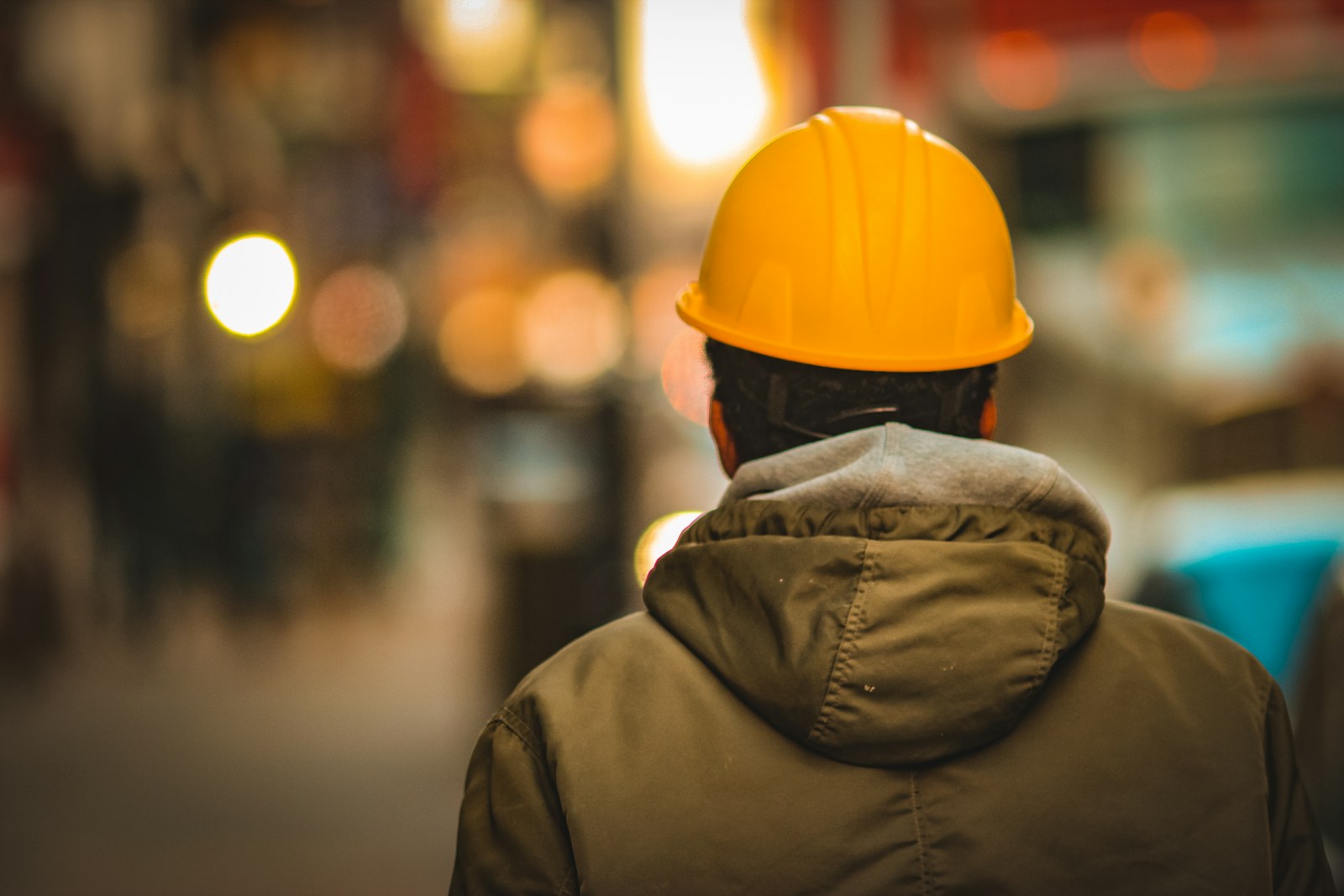 Hire staff person in yellow hard hat and brown jacket
