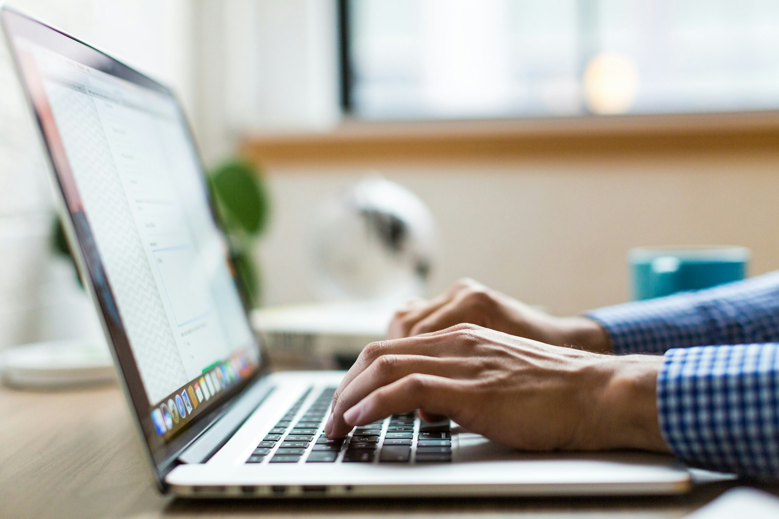 Find Work person typing on silver MacBook