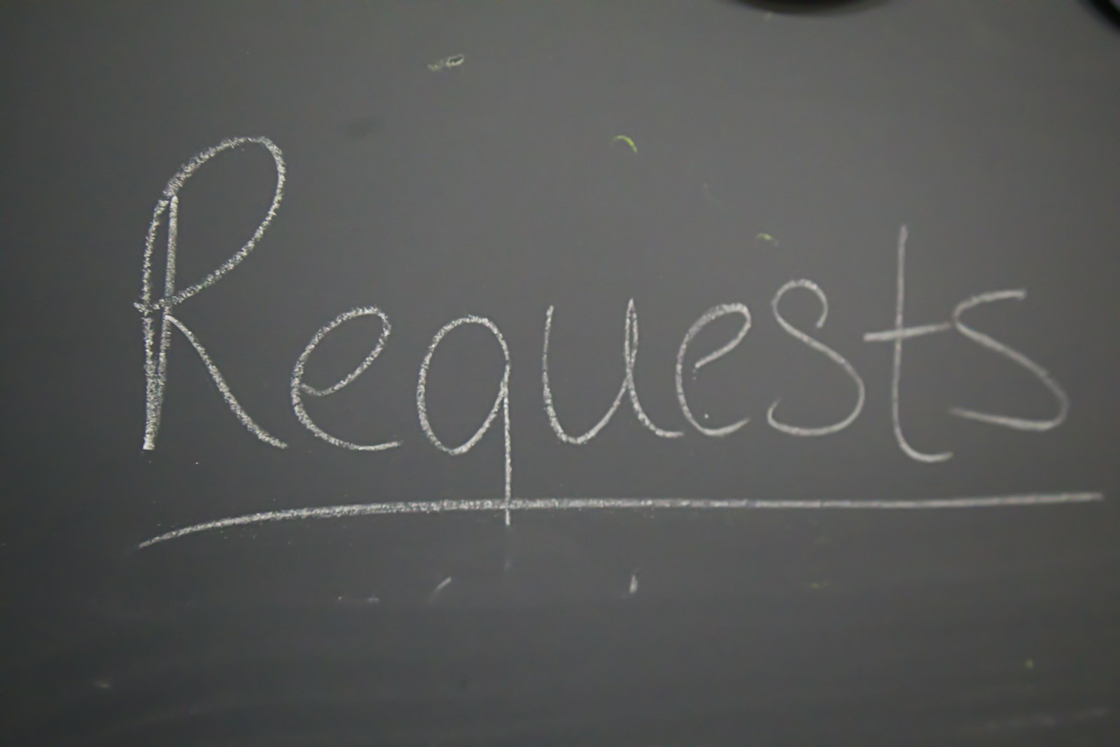photo by jacob mcgowin A chalkboard with the word request written on it